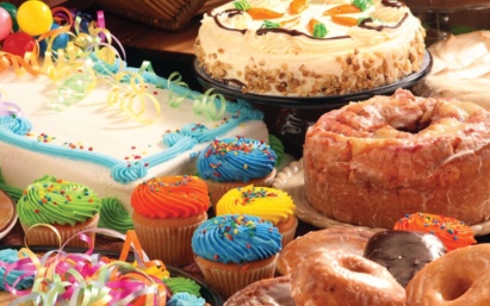Photo of assorted cakes, donuts and cupcakes.