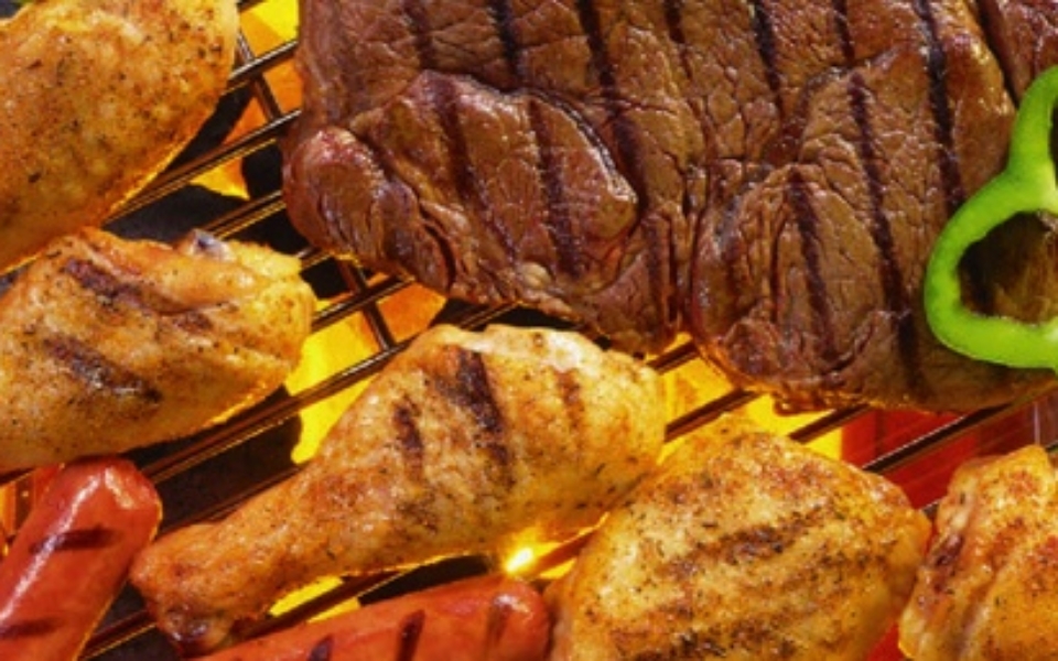 Variety of meat on a grill.